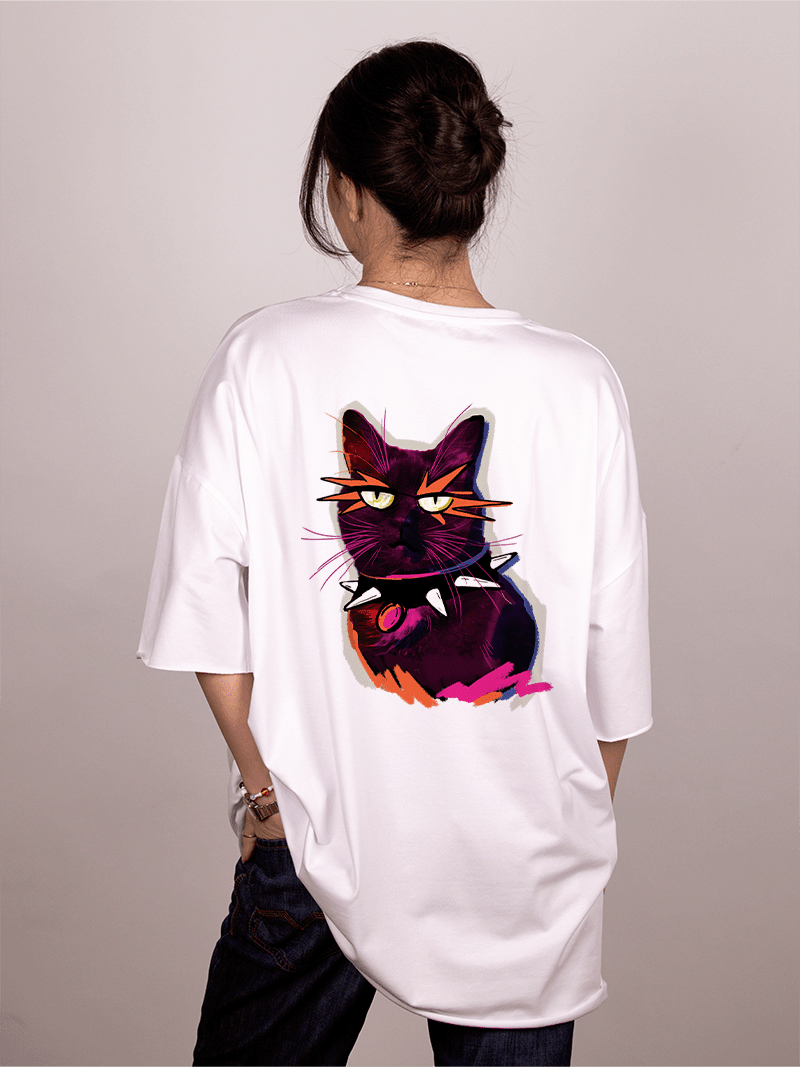 Girl wearing a white "Ivica i Majica" t-shirt with a colorful cat graphic on the back against a plain background