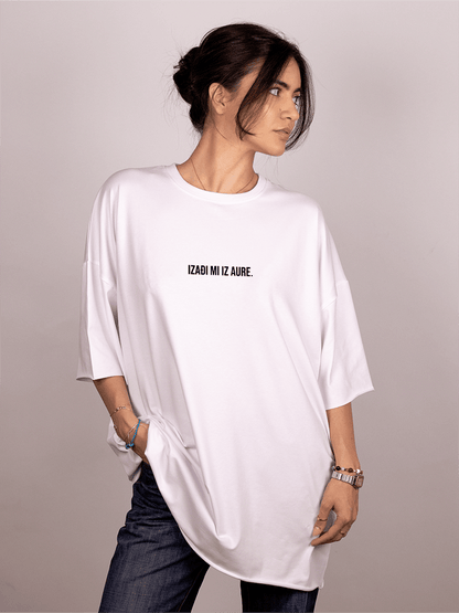 Person wearing a white oversized "Ivica i Majica" t-shirt with text on a plain background