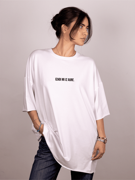 Person wearing a white oversized "Ivica i Majica" t-shirt with text on a plain background